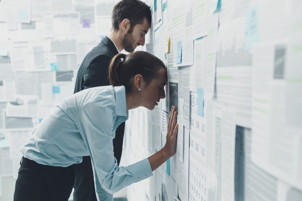 Exhausted business team overloaded with KPI reports